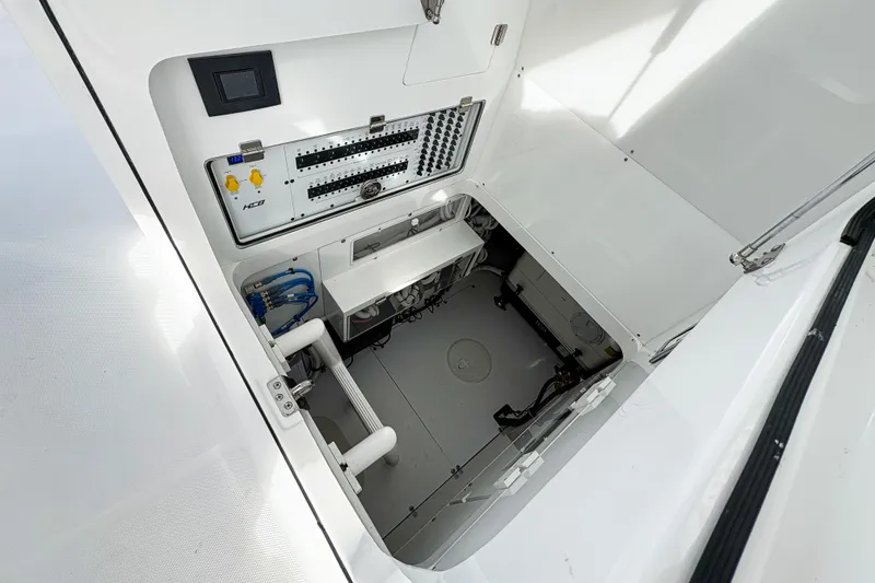 Slide: The Image of Engine compartment of 2027 HCB 48 Campeon boat, showcasing control panel and wiring. - 29