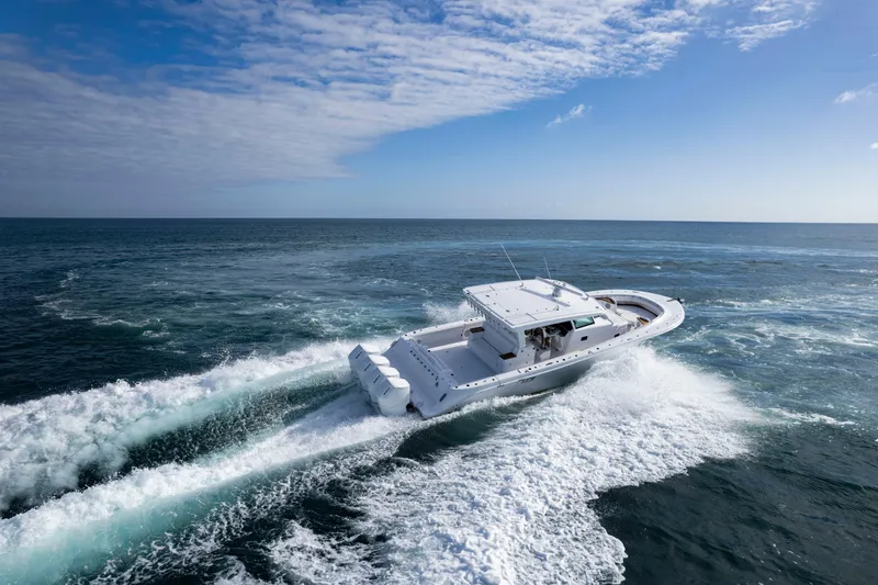 Slide: The Image of 2027 HCB 48 Campeon cruising on open ocean under clear blue sky. - 3