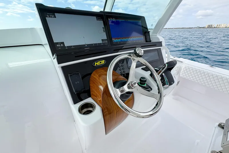 Slide: The Image of Helm of 2027 HCB 48 Campeon boat with modern navigation displays and controls. - 33