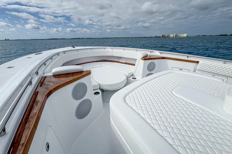 Slide: The Image of Luxurious 2027 HCB 48 Campeon yacht interior with white quilted seating and ocean view. - 41