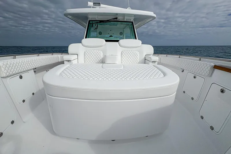Slide: The Image of Luxurious 2027 HCB 48 Campeon boat interior with plush white seating and ocean backdrop. - 44
