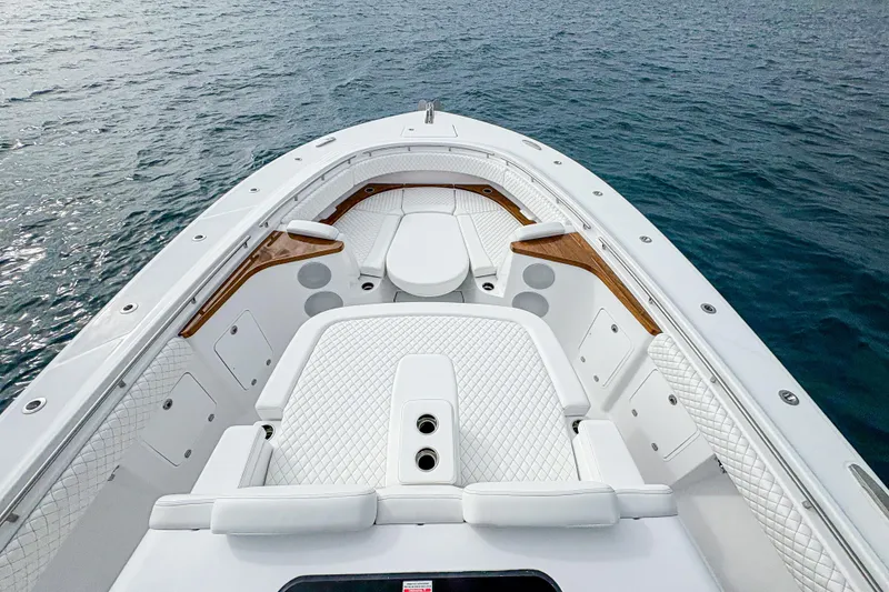Slide: The Image of 2027 HCB 48 Campeon boat with luxurious white seating on calm water. - 45