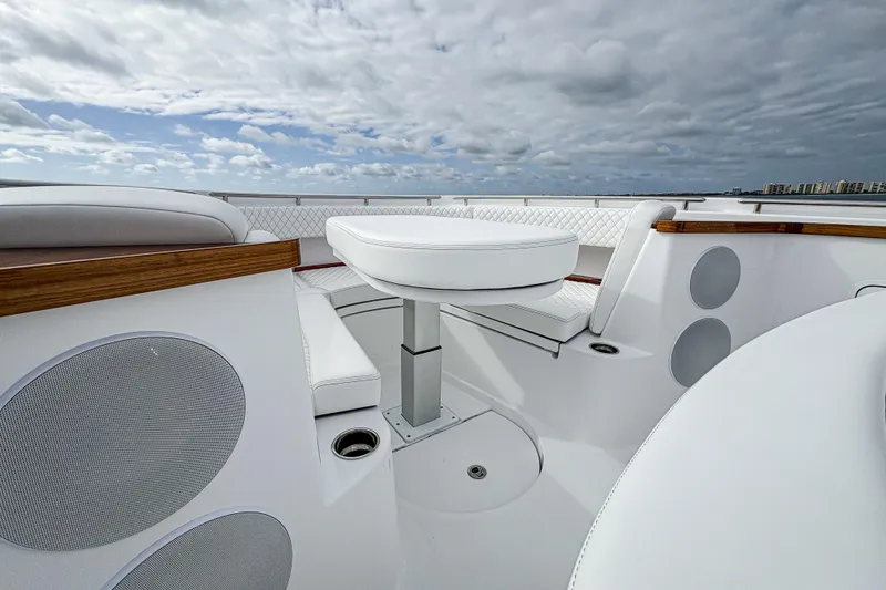 Slide: The Image of Luxurious seating area on the 2027 HCB 48 Campeon boat under a cloudy sky. - 46