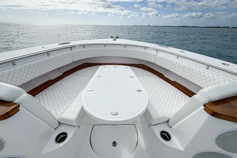 Slide: The Image of Luxurious seating area on 2027 HCB 48 Campeon boat, featuring elegant white upholstery. - 49