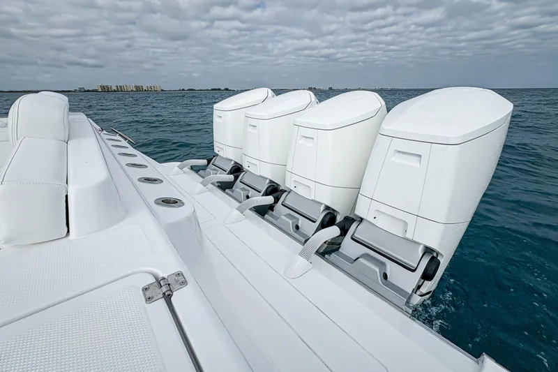 Slide: The Image of 2027 HCB 48 Campeon boat with four powerful outboard engines on open water. - 53