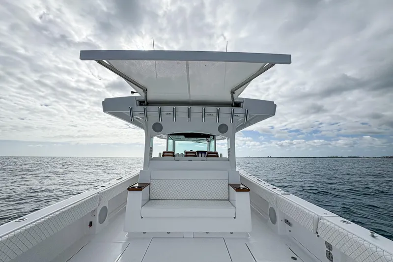 Slide: The Image of 2027 HCB 48 Campeon boat on open water under cloudy sky. - 56