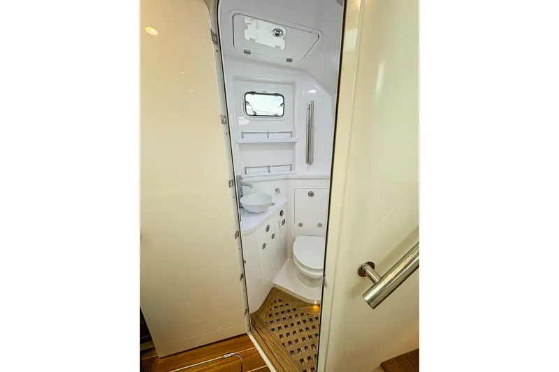 Slide: The Image of 2027 HCB 48 Campeon boat bathroom with modern fixtures and wooden flooring. - 67