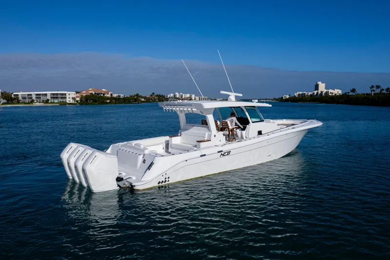Slide: The Image of 2027 HCB 48 Campeon boat on calm water, clear sky background. - 7