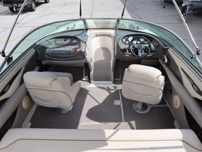 Slide: The Image of Interior of a 2001 Monterey 200LS boat with beige seating. - 11