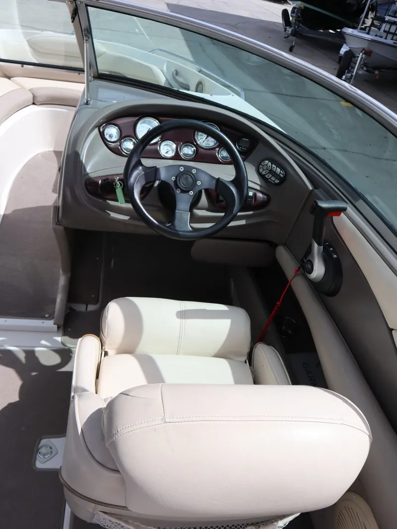 Slide: The Image of Interior of a 2001 Monterey 200LS boat with steering console. - 12