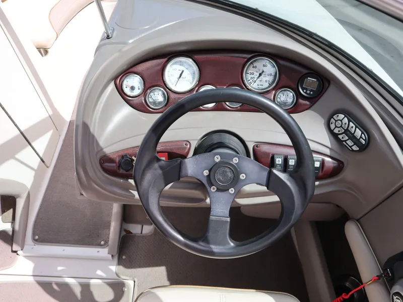 Slide: The Image of Steering wheel and dashboard of a 2001 Monterey 200LS boat. - 13