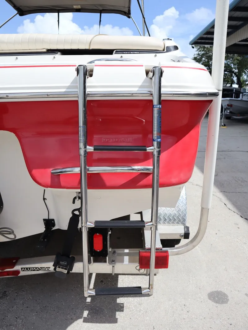 Slide: The Image of Red 2001 Monterey 200LS boat with rear ladder. - 22