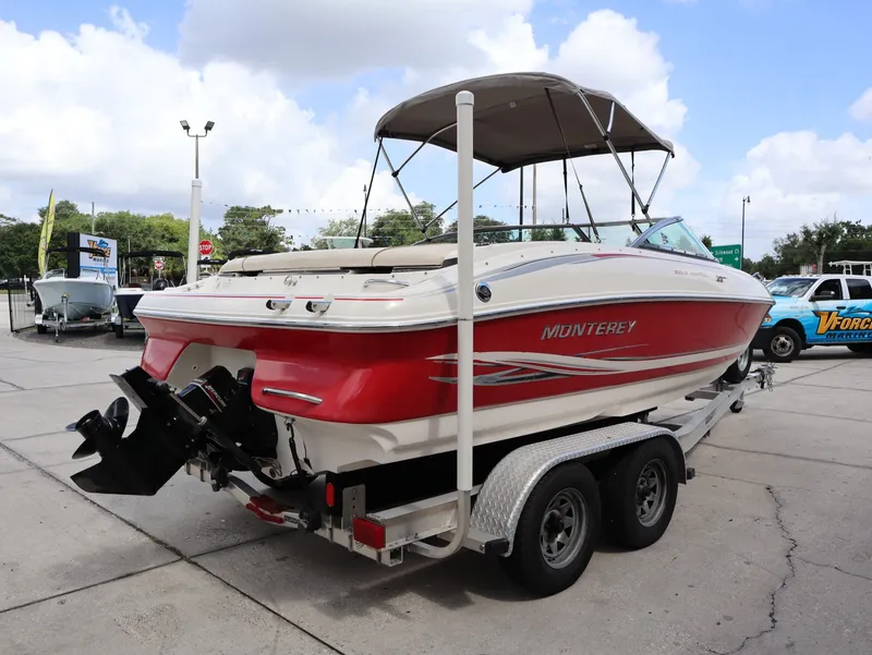 Slide: The Image of Red 2001 Monterey 200LS boat on trailer outdoors. - 7