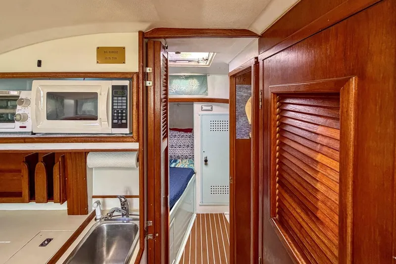 Slide: The Image of Interior of 1987 Nonsuch 30 Ultra sailboat with kitchenette and cozy cabin. - 13