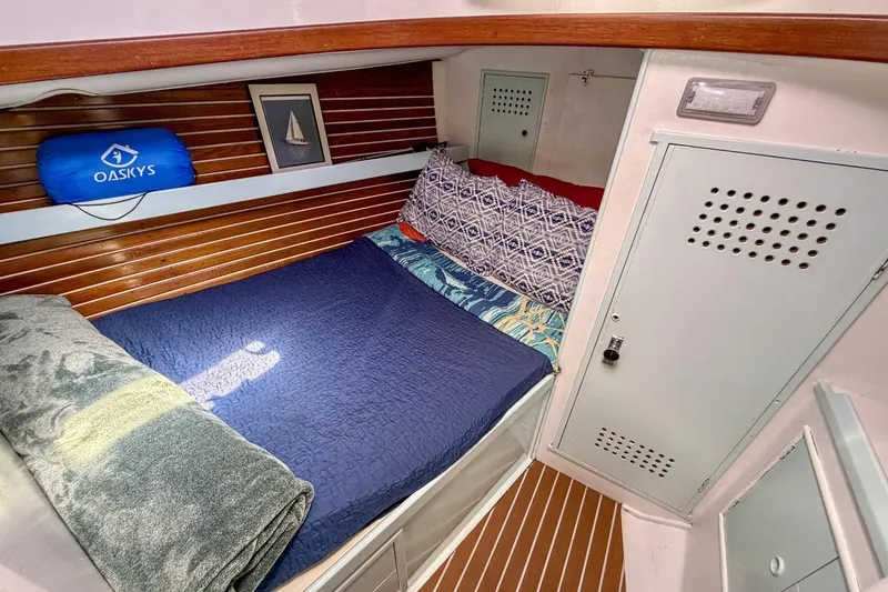 Slide: The Image of Cozy cabin interior of 1987 Nonsuch 30 Ultra sailboat with bed and storage. - 14