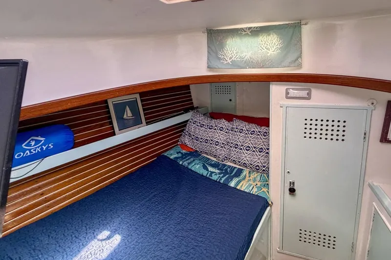 Slide: The Image of Cozy cabin interior of 1987 Nonsuch 30 Ultra sailboat with nautical decor. - 15