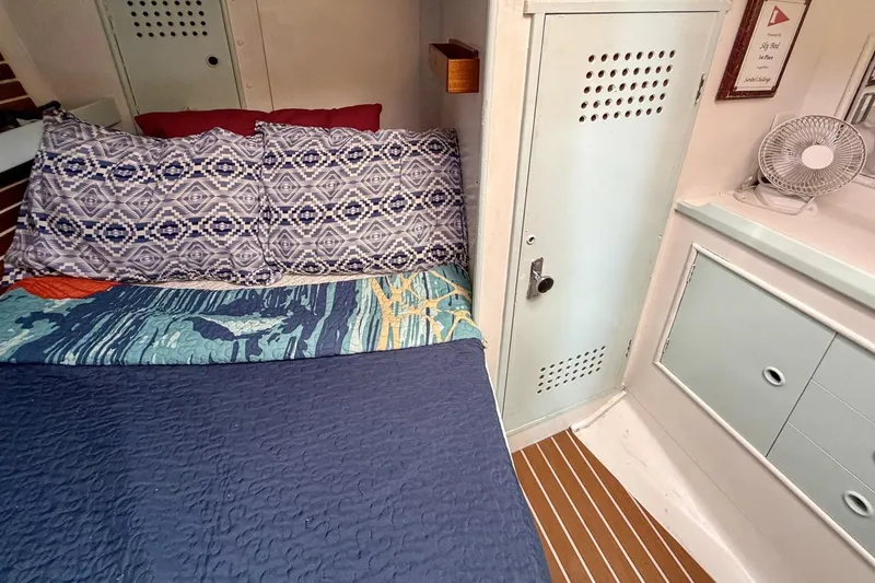 Slide: The Image of Cozy cabin interior of 1987 Nonsuch 30 Ultra sailboat with patterned bedding. - 16