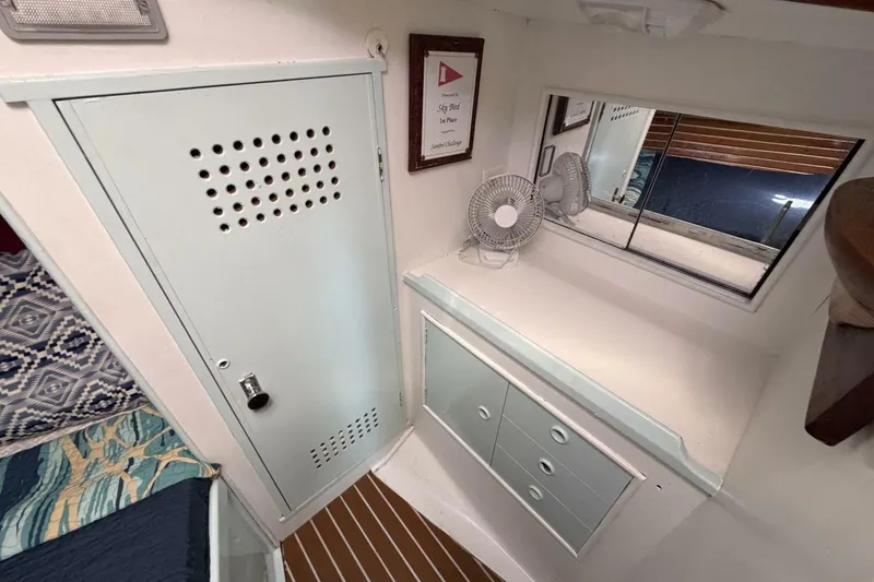 Slide: The Image of Interior of 1987 Nonsuch 30 Ultra sailboat with storage, fan, and window. - 17
