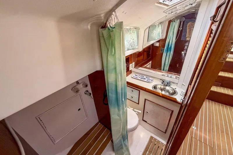 Slide: The Image of 1987 Nonsuch 30 Ultra yacht bathroom with shower, sink, and wooden flooring. - 20