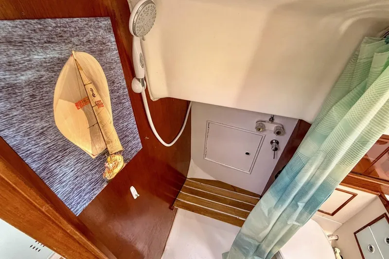 Slide: The Image of Interior of 1987 Nonsuch 30 Ultra sailboat bathroom with shower and nautical decor. - 21