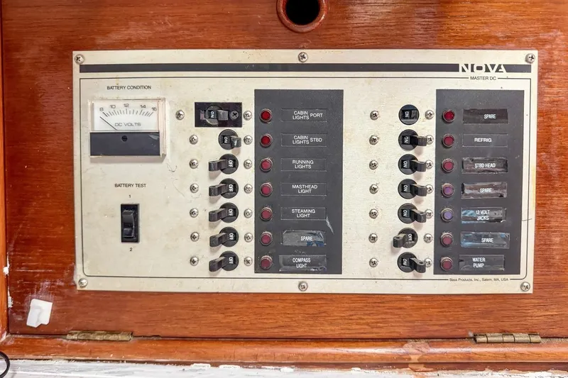 Slide: The Image of Electrical control panel on a 1987 Nonsuch 30 Ultra sailboat, featuring switches and battery gauge. - 22
