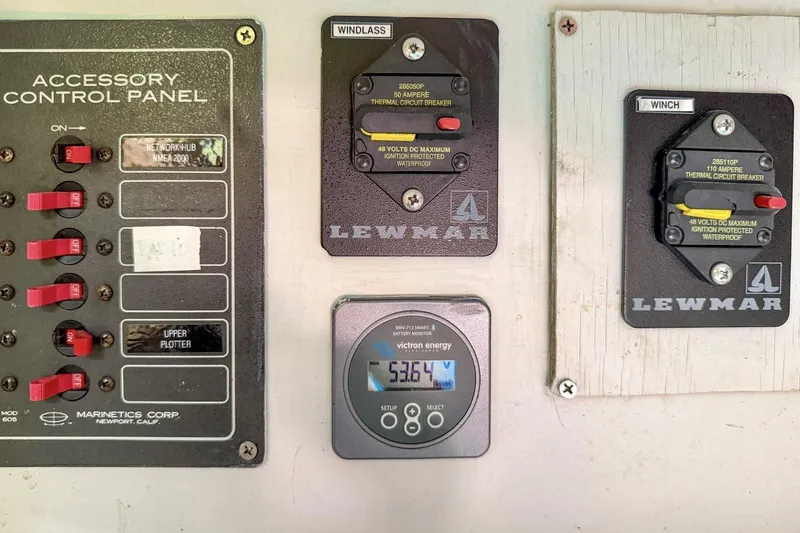 Slide: The Image of Control panel of a 1987 Nonsuch 30 Ultra sailboat with circuit breakers and battery monitor. - 23