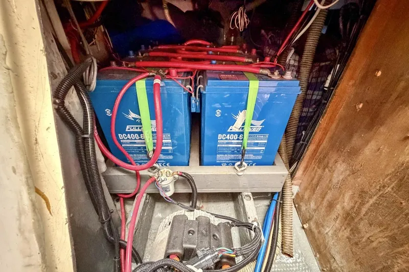 Slide: The Image of Battery compartment of a 1987 Nonsuch 30 Ultra sailboat with wiring and connections. - 29