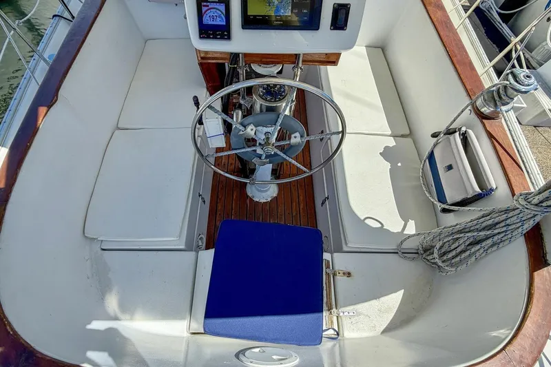 Slide: The Image of Cockpit of 1987 Nonsuch 30 Ultra sailboat with steering wheel and navigation instruments. - 31