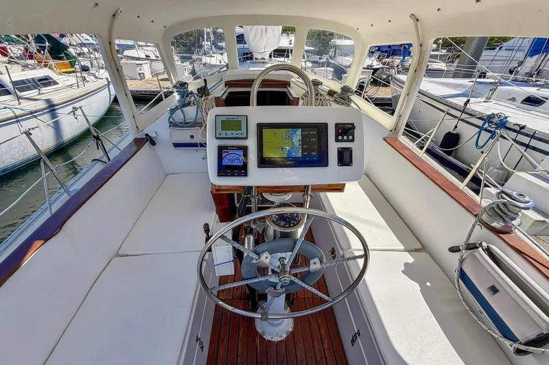 Slide: The Image of Cockpit of 1987 Nonsuch 30 Ultra sailboat with navigation equipment and steering wheel. - 32