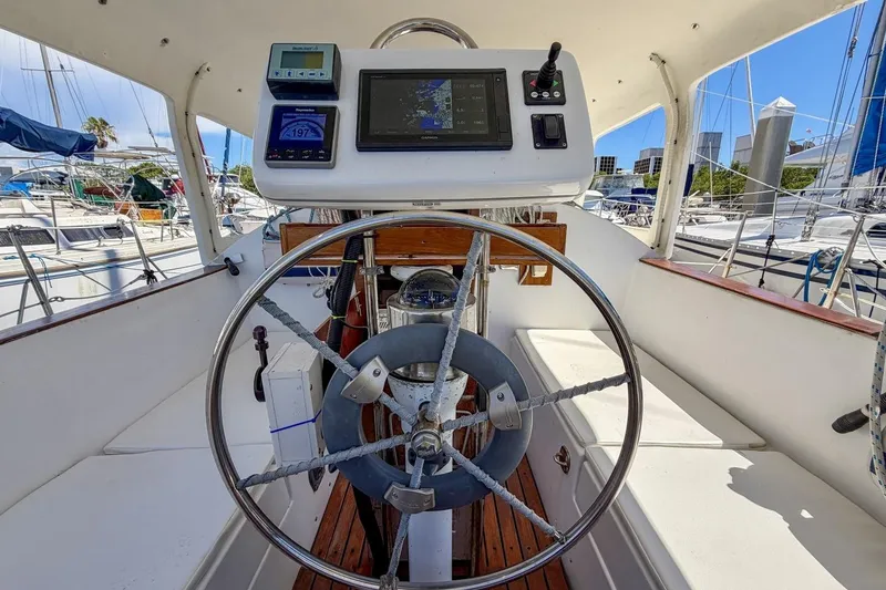 Slide: The Image of Cockpit of 1987 Nonsuch 30 Ultra sailboat with steering wheel and navigation instruments. - 33