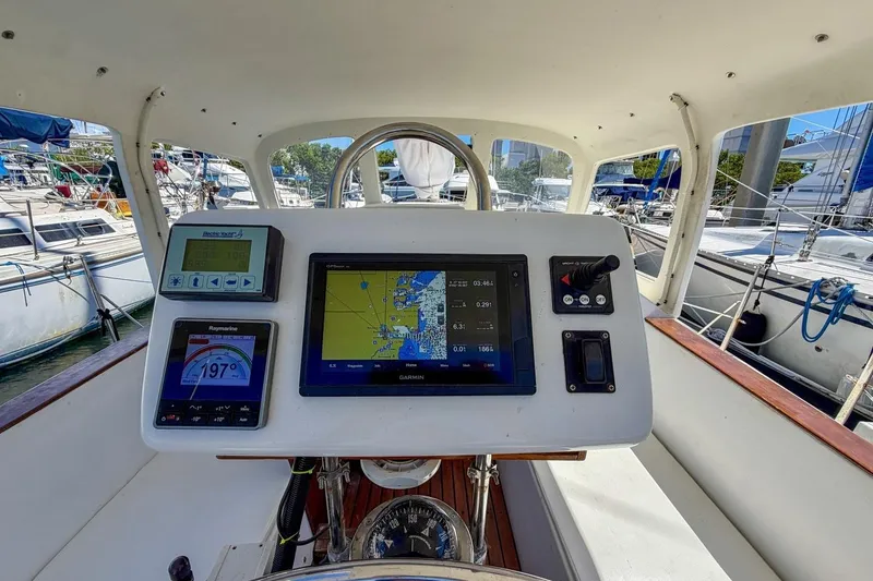 Slide: The Image of Cockpit of 1987 Nonsuch 30 Ultra sailboat with navigation instruments and steering wheel. - 34