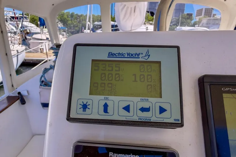 Slide: The Image of Electric Yacht display on 1987 Nonsuch 30 Ultra sailboat, docked with marina view. - 35
