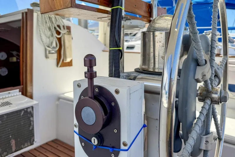 Slide: The Image of Cockpit of 1987 Nonsuch 30 Ultra sailboat featuring steering wheel and control panel. - 36