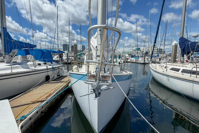 Slide: The Image of 1987 Nonsuch 30 Ultra sailboat docked in a marina under a blue sky. - 4