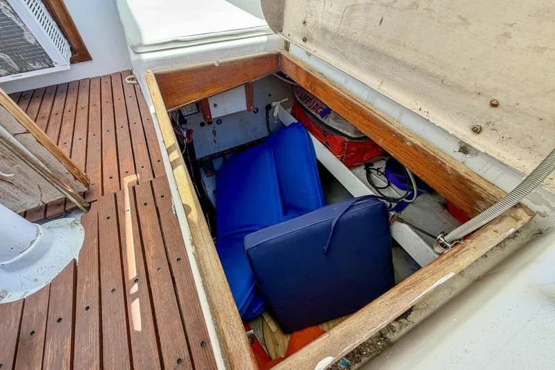 Slide: The Image of Open storage compartment on 1987 Nonsuch 30 Ultra sailboat with cushions and life jackets. - 40