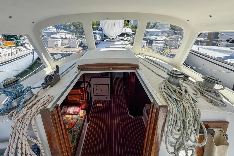 Slide: The Image of Interior view of 1987 Nonsuch 30 Ultra sailboat, showcasing cabin entrance and deck details. - 41