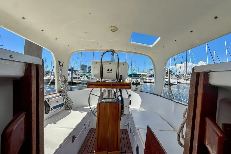 Slide: The Image of Interior view of 1987 Nonsuch 30 Ultra sailboat cockpit at marina. - 42