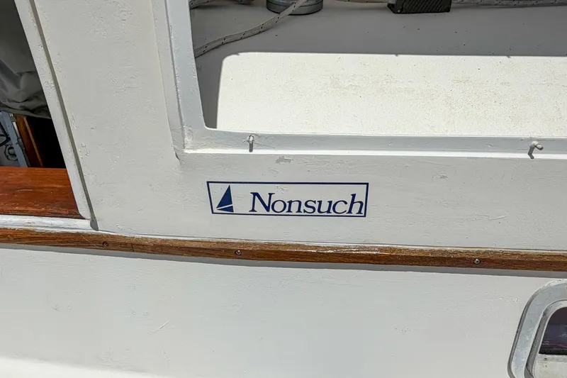 Slide: The Image of Nonsuch 30 Ultra sailboat, 1987 model, featuring logo and wooden trim detail. - 5