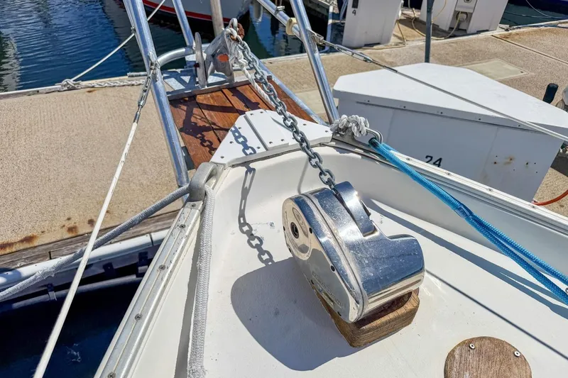 Slide: The Image of Bow of 1987 Nonsuch 30 Ultra sailboat with anchor chain and winch at dock. - 51