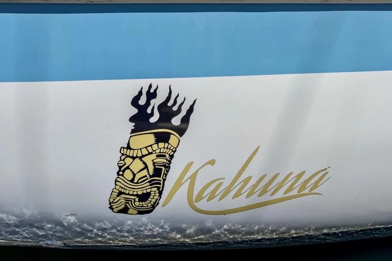 Slide: The Image of 1987 Nonsuch 30 Ultra boat with "Kahuna" logo and tiki design on hull. - 52