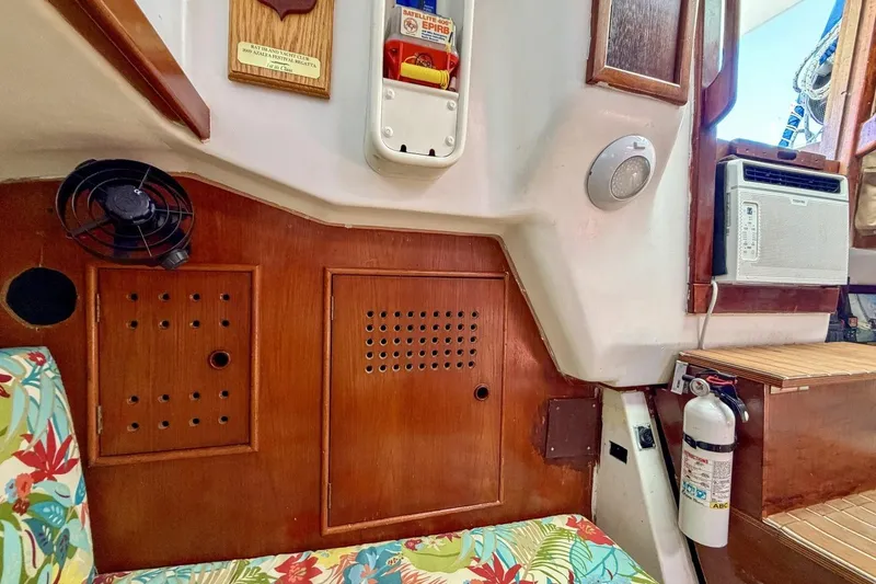 Slide: The Image of Interior of 1987 Nonsuch 30 Ultra sailboat with wood paneling and floral upholstery. - 8