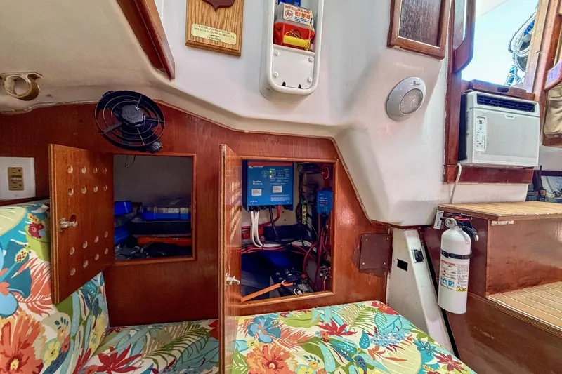 Slide: The Image of Interior of 1987 Nonsuch 30 Ultra sailboat with floral upholstery and electrical panel. - 9
