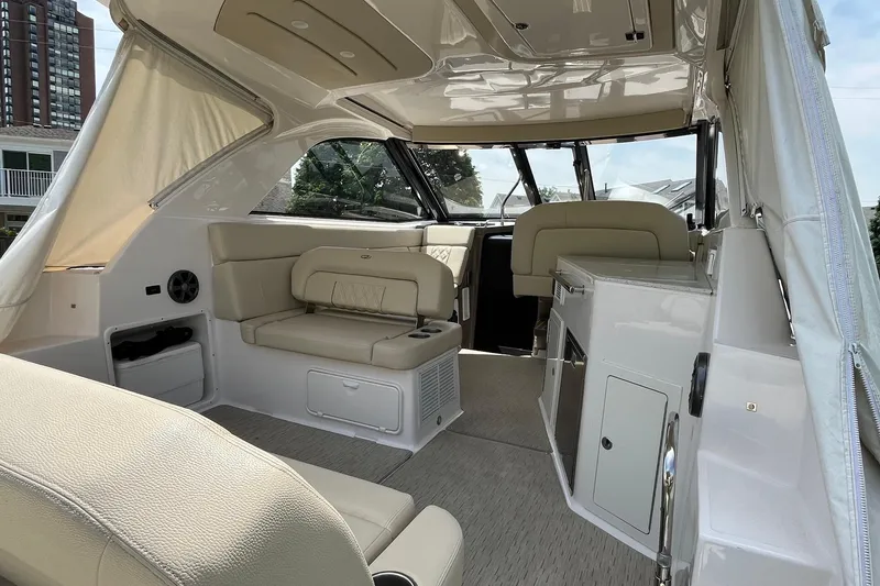 Slide: The Image of Luxurious interior of a 2018 Regal 35 Sport Coupe yacht with beige seating and modern amenities. - 17