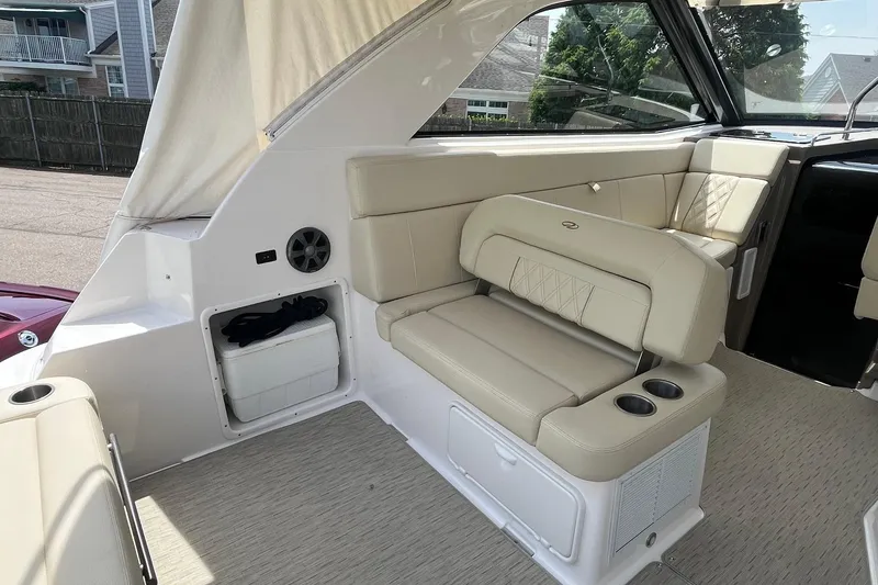 Slide: The Image of 2018 Regal 35 Sport Coupe interior with beige seating and cup holders. - 18