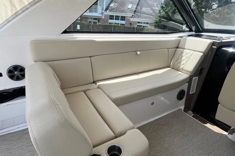 Slide: The Image of Luxurious beige seating in a 2018 Regal 35 Sport Coupe boat interior. - 22