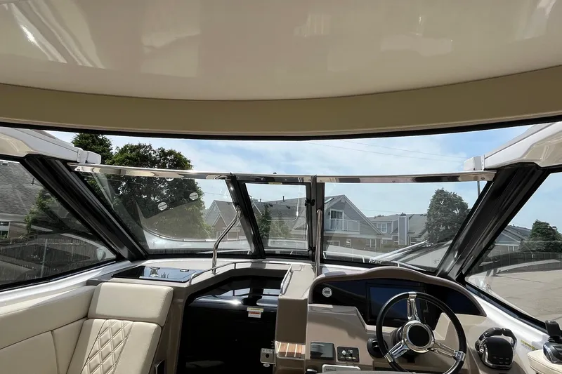 Slide: The Image of Interior view of 2018 Regal 35 Sport Coupe boat cockpit with steering wheel and dashboard. - 25