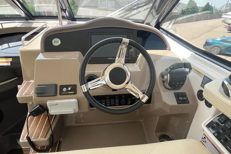 Slide: The Image of 2018 Regal 35 Sport Coupe helm with steering wheel and navigation controls. - 30