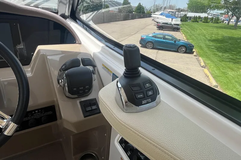 Slide: The Image of Control panel of a 2018 Regal 35 Sport Coupe boat with joystick and throttle. - 31