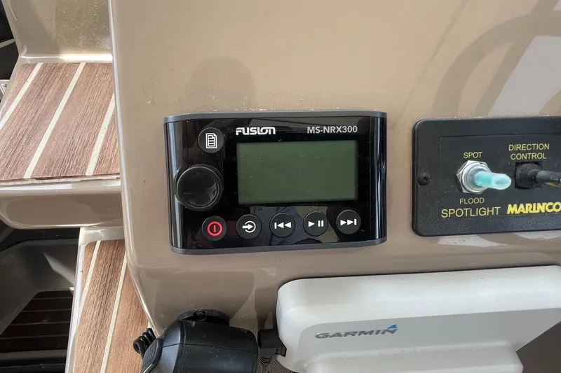 Slide: The Image of Control panel of a 2018 Regal 35 Sport Coupe with Fusion MS-NRX300 and Marinco spotlight controls. - 32
