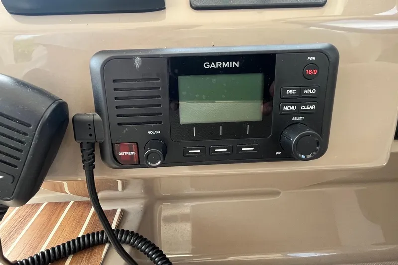 Slide: The Image of Garmin marine radio on 2018 Regal 35 Sport Coupe dashboard, featuring distress button and controls. - 33